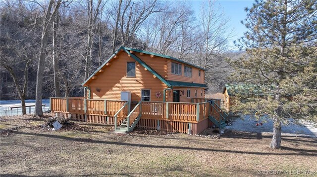 rear view of property featuring a deck