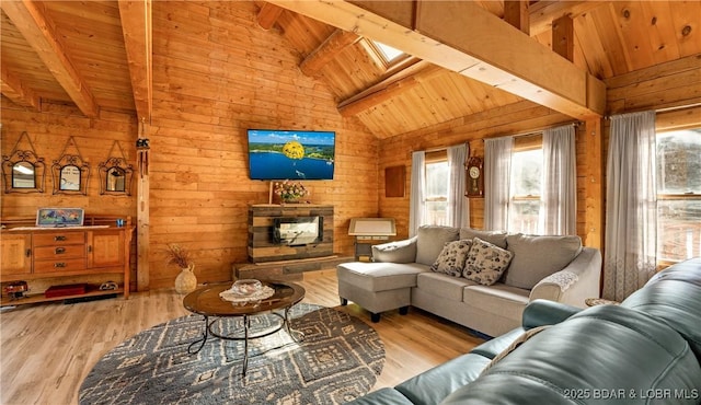 living room with wood walls, vaulted ceiling with skylight, light hardwood / wood-style flooring, and wooden ceiling