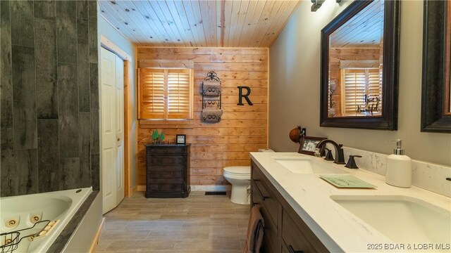 bathroom with toilet, wood ceiling, vanity, wooden walls, and a bathing tub