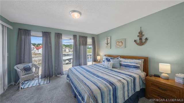 bedroom featuring a textured ceiling and carpet