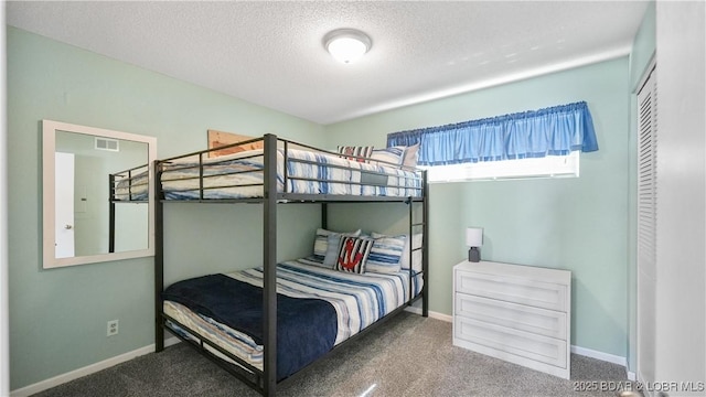 bedroom featuring carpet and a textured ceiling