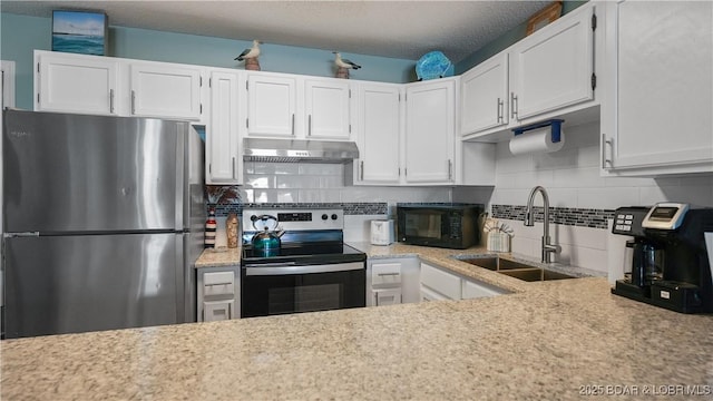 kitchen featuring electric range oven, white cabinetry, sink, stainless steel fridge, and decorative backsplash