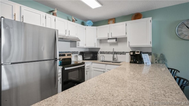 kitchen with stainless steel appliances, white cabinetry, sink, and decorative backsplash