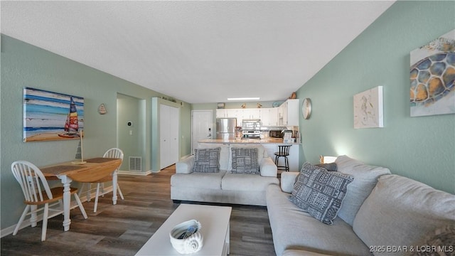 living room featuring dark wood-type flooring