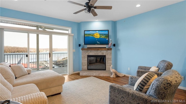 living room featuring hardwood / wood-style flooring and ceiling fan