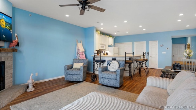 living room featuring dark hardwood / wood-style floors and ceiling fan