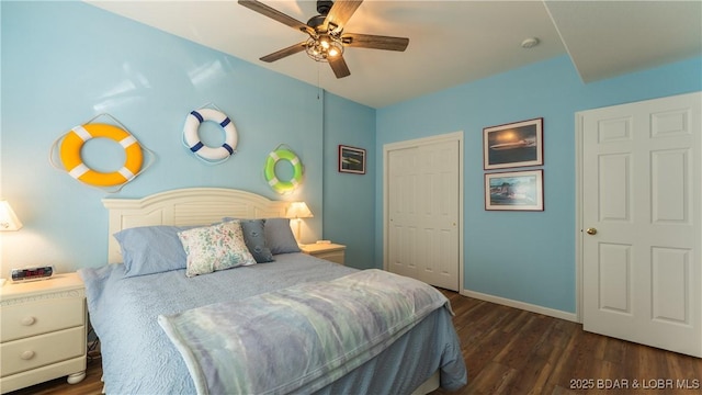 bedroom featuring ceiling fan, dark hardwood / wood-style flooring, and a closet