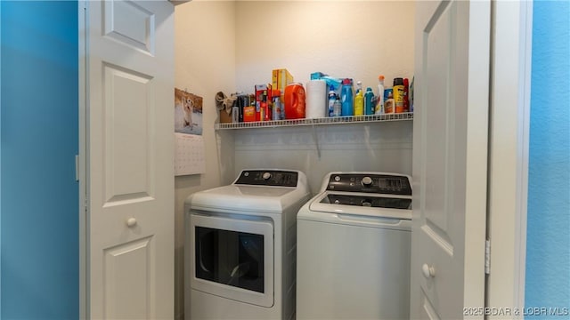 washroom with washing machine and clothes dryer