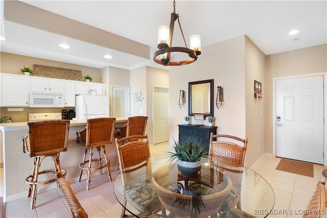 dining area with light tile patterned flooring and a chandelier