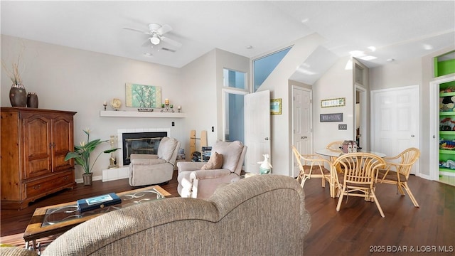 living room featuring hardwood / wood-style flooring, ceiling fan, and vaulted ceiling