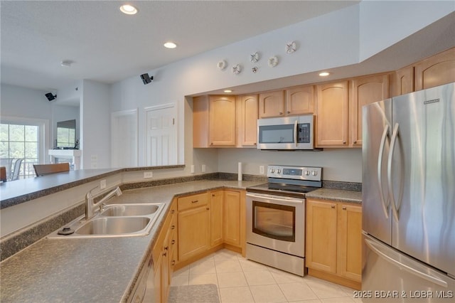 kitchen featuring sink, light tile patterned floors, stainless steel appliances, and light brown cabinets