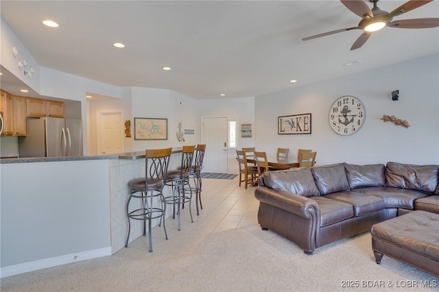 living room with light tile patterned floors and ceiling fan