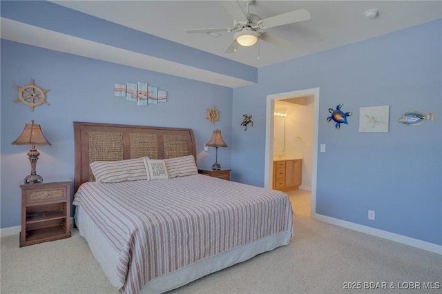 bedroom featuring ceiling fan, light colored carpet, and ensuite bath