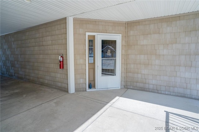 doorway to property with a patio area