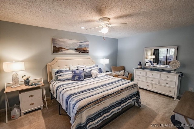 bedroom featuring ceiling fan, a textured ceiling, and dark colored carpet