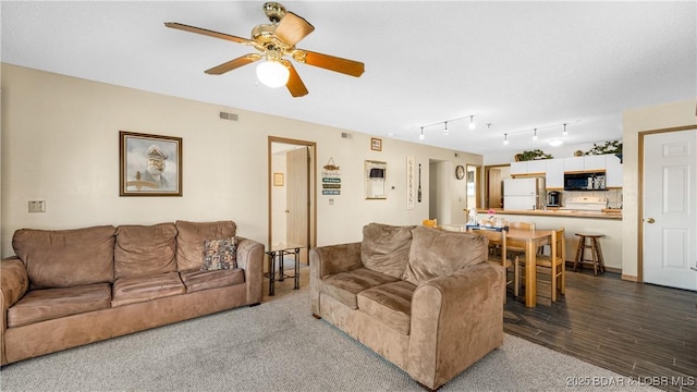 living room featuring hardwood / wood-style floors and ceiling fan