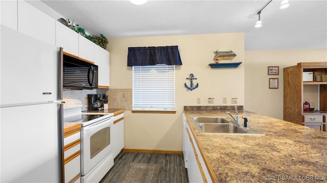 kitchen featuring sink, white cabinets, dark hardwood / wood-style flooring, white appliances, and a textured ceiling