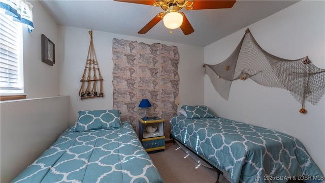 carpeted bedroom with a textured ceiling and ceiling fan