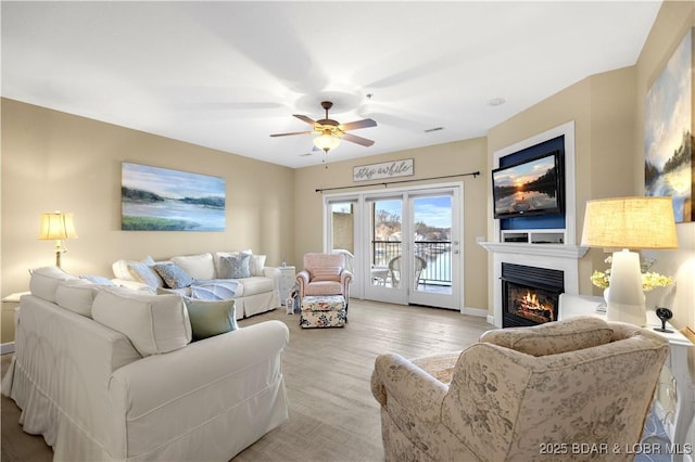 living room with wood-type flooring and ceiling fan