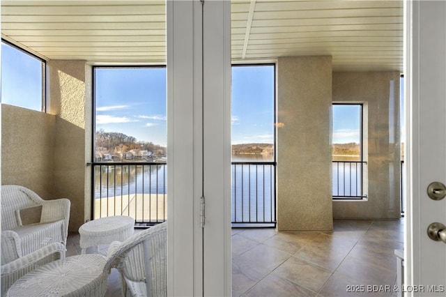 sunroom / solarium with a water view