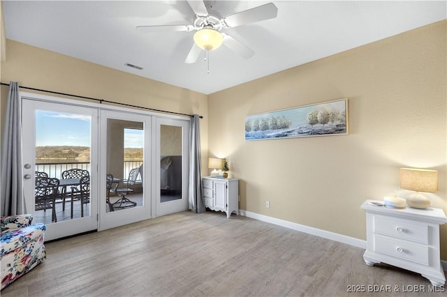 interior space with ceiling fan and light hardwood / wood-style flooring