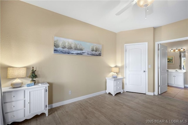 unfurnished bedroom with connected bathroom, ceiling fan, and light hardwood / wood-style flooring