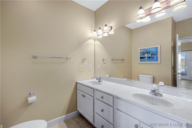 bathroom featuring vanity, toilet, and tile patterned flooring