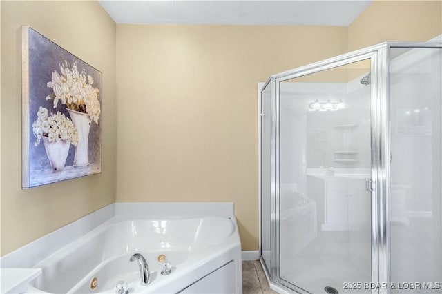 bathroom with independent shower and bath and tile patterned flooring