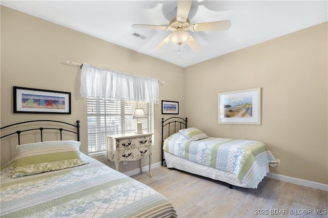 bedroom with light hardwood / wood-style flooring and ceiling fan