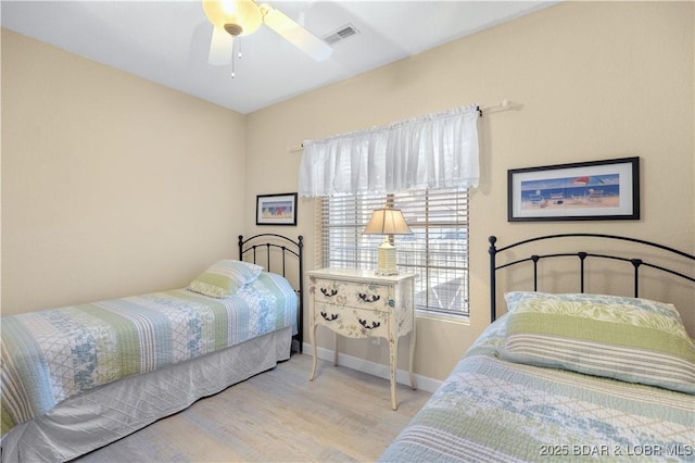 bedroom with ceiling fan and light hardwood / wood-style floors