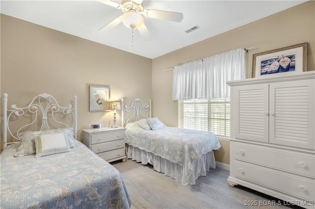 bedroom with ceiling fan and light hardwood / wood-style flooring