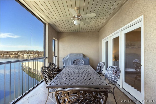 balcony with a water view and ceiling fan