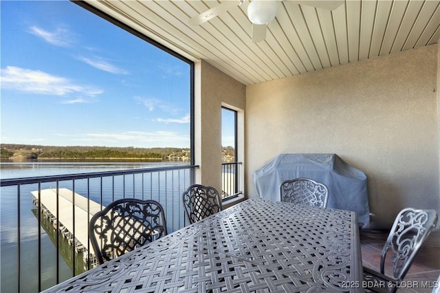 interior space featuring a water view, area for grilling, and ceiling fan