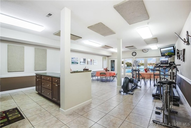 exercise room featuring light tile patterned floors