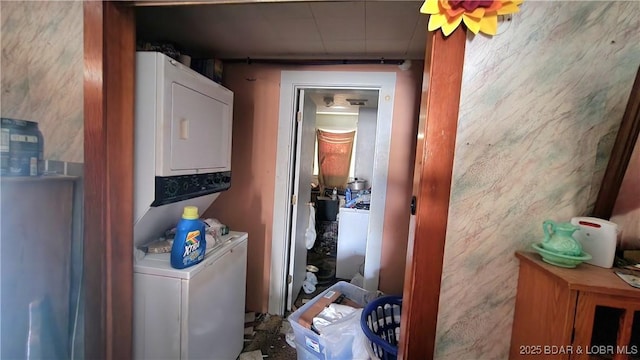 washroom featuring stacked washer / drying machine