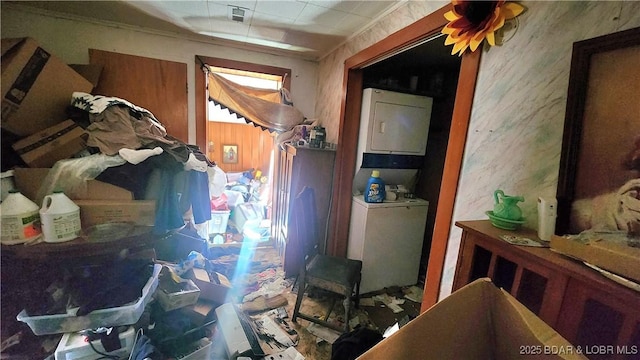 miscellaneous room featuring stacked washer and dryer