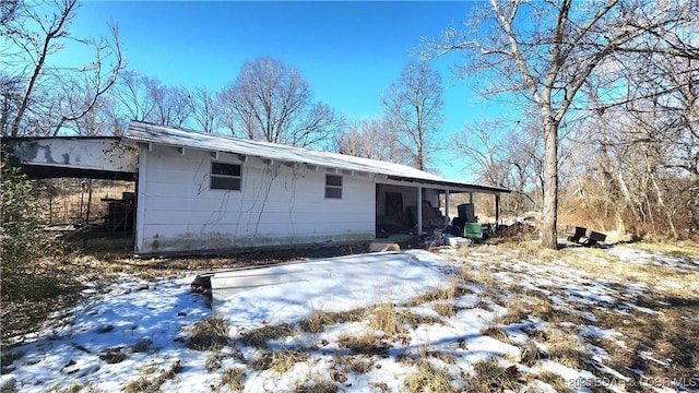 view of snow covered rear of property