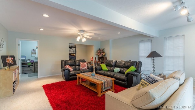 living room with beamed ceiling, light colored carpet, and ceiling fan