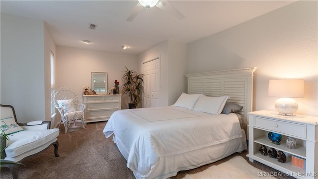 carpeted bedroom featuring ceiling fan and a closet