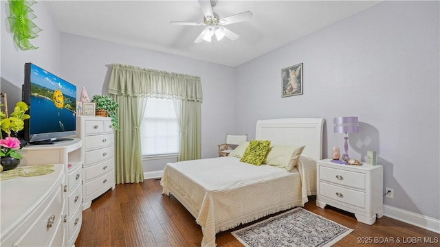 bedroom with dark hardwood / wood-style flooring and ceiling fan