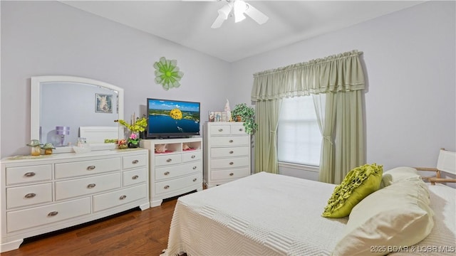 bedroom featuring dark hardwood / wood-style flooring, lofted ceiling, and ceiling fan