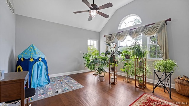 interior space with ceiling fan, plenty of natural light, high vaulted ceiling, and hardwood / wood-style floors