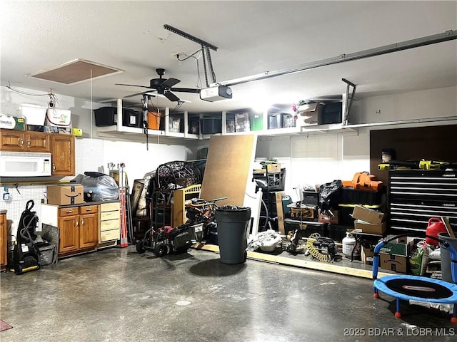 garage with ceiling fan and a garage door opener