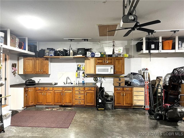 kitchen with tasteful backsplash, sink, a textured ceiling, and ceiling fan