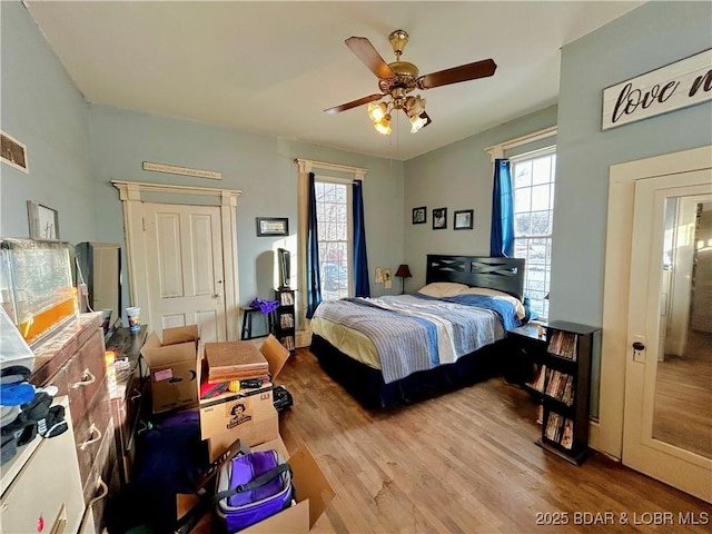 bedroom with hardwood / wood-style floors and ceiling fan