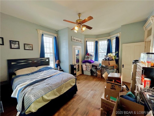 bedroom featuring ceiling fan and light hardwood / wood-style flooring