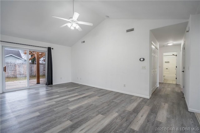 empty room with hardwood / wood-style floors, high vaulted ceiling, and ceiling fan