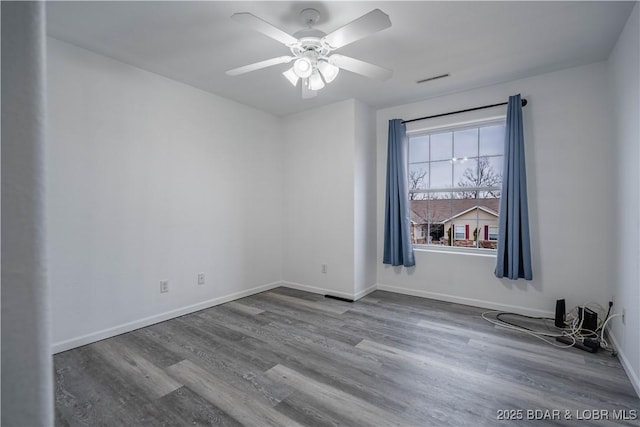 spare room featuring hardwood / wood-style flooring and ceiling fan