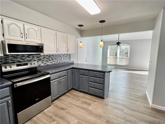 kitchen featuring gray cabinets, white cabinetry, appliances with stainless steel finishes, and hanging light fixtures