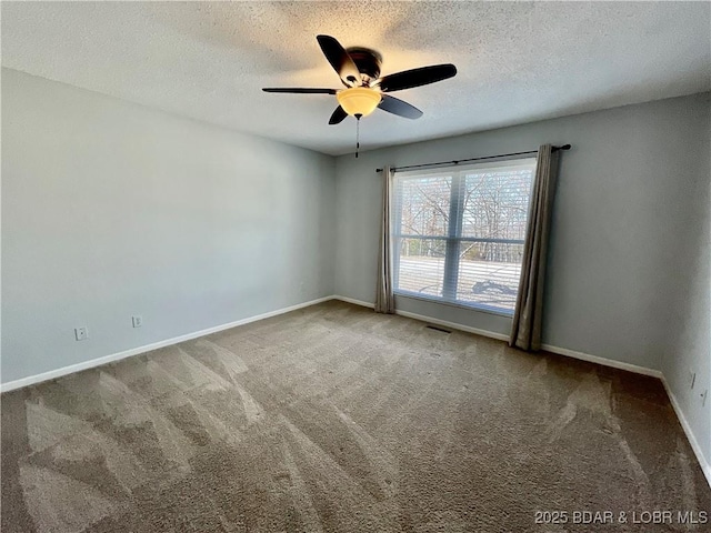 carpeted spare room featuring a textured ceiling and ceiling fan